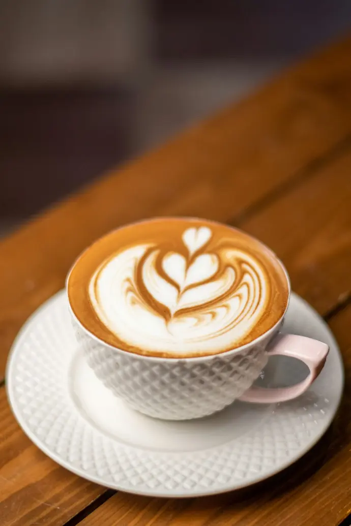 white ceramic cup with saucer on brown wooden table